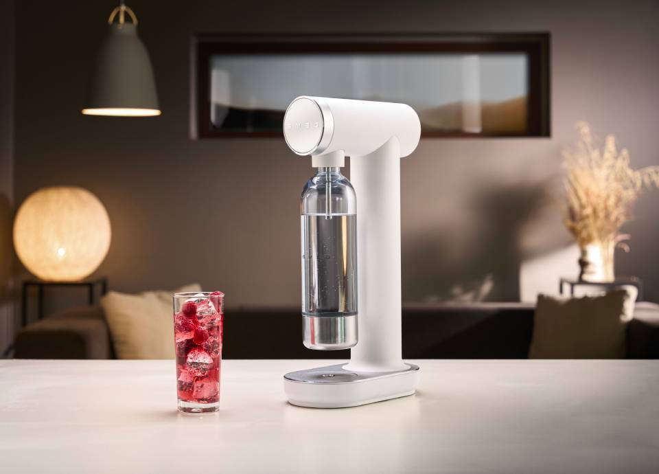 Gasatore Smeg bianco con bicchiere di acqua frizzante aromatizzata
